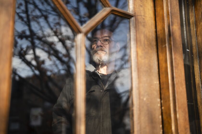 Danny Wenz, a resident of an apartment in the 3000 block of West Bell Plaine Avenue in the Irving Park neighborhood for about five years, stands in the doorway of the building, Thursday, Jan. 11, 2024. Wenz is among several tenants who have complaints about their landlord, who Wenz says charges $50 to unclog a toilet, $50 for internet or cable installation and $125 to unlock a renter’s apartment door in the event of an accidental lockout. | Pat Nabong/Sun-Times