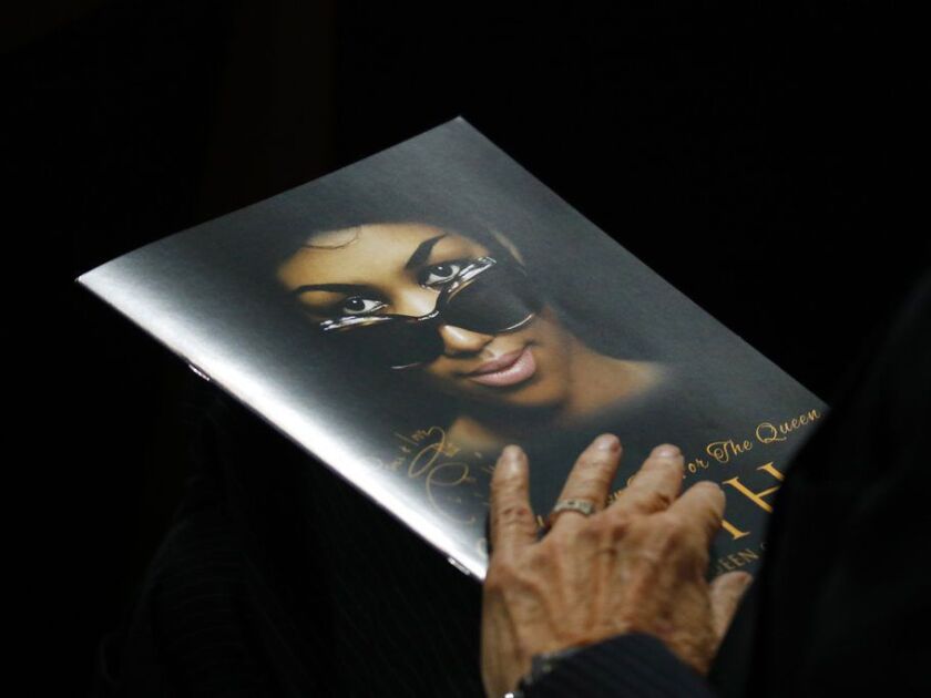 A person holds a program during the funeral service for Aretha Franklin at Greater Grace Temple on Aug. 31, 2018 in Detroit. | AP