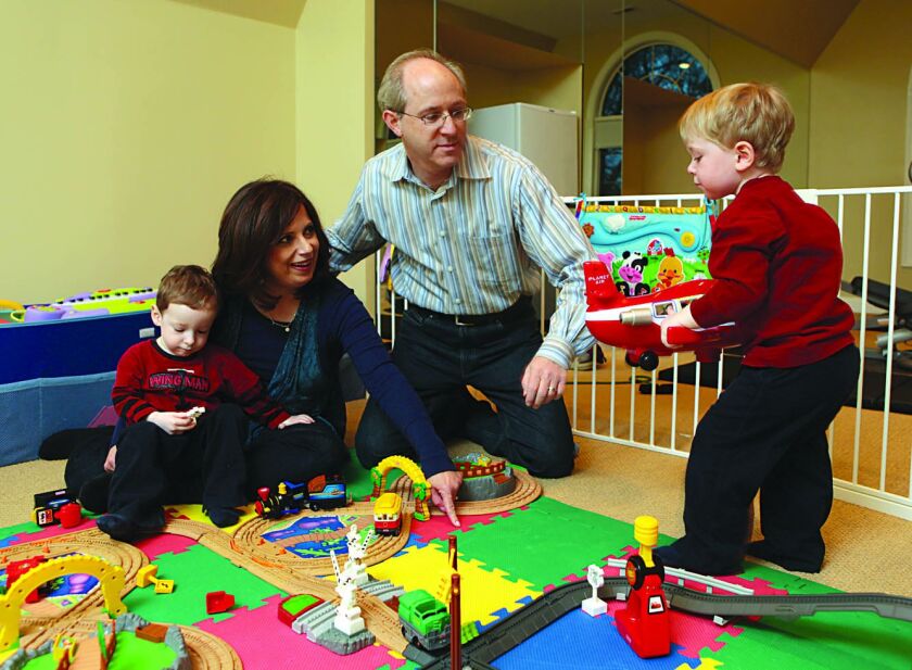 Gail Fink and husband Michael and their twins, Elliot Raymond (blonde, train shirt) and Ethan Benjamin (wing man shirt), in 2010.