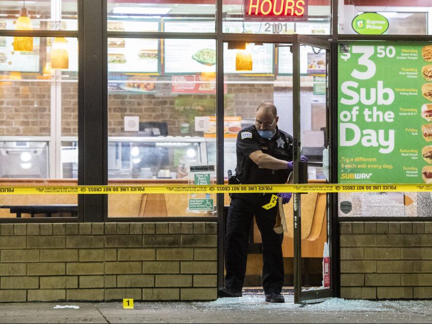 Police investigate a person shot Saturday morning in the 2100 block of East 71st Street at a Subway. | Tyler LaRiviere/Sun-Times