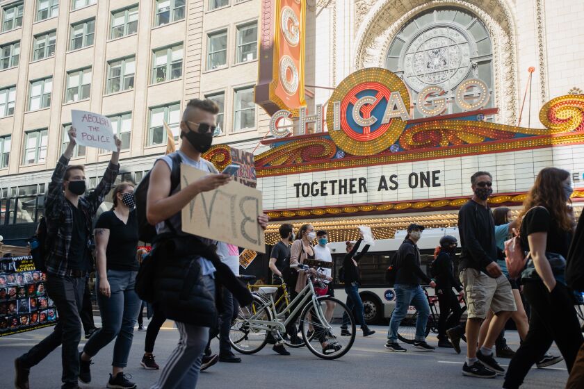 Hundreds of protesters march Saturday along State Street.