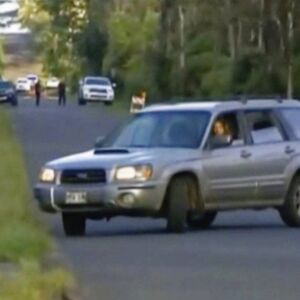 A driver makes a U-turn as the road was blocked after Hawaii County ordered evacuations. | KHON via AP