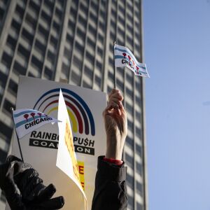 Chicago flags with bullet holes instead of red stars were featured during an anti-violence protest Thursday along the Magnificent Mile.