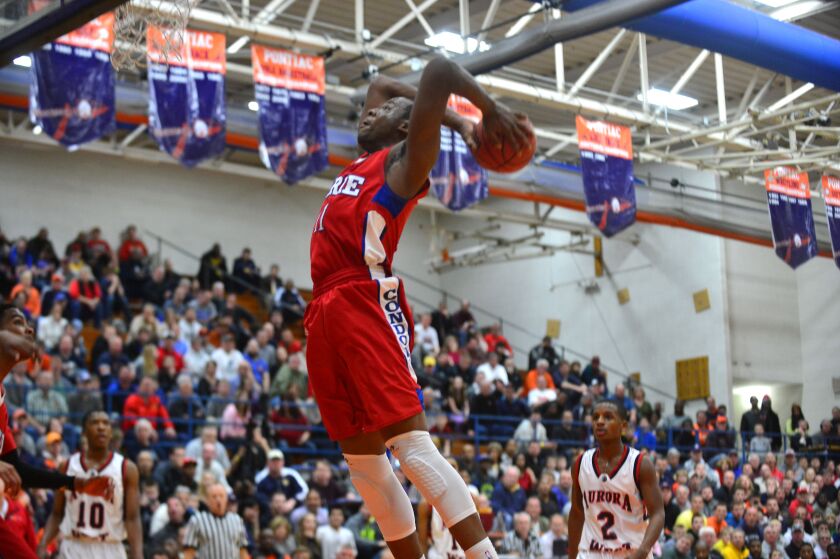 Curie’s Cliff Alexander reaches back to slam against West Aurora.