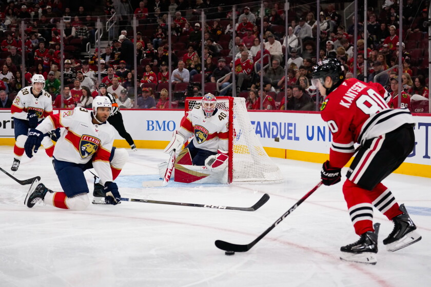 Roman Kantserov skates with the puck while Seth Jones (front left) defends during the second period Sunday.