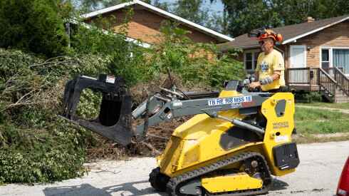 Wendell Romans, a volunteer from Texas, helps clear downed trees on Van Buren Street near 20th Place in Gary on Wednesday, Aug. 26, 2026.