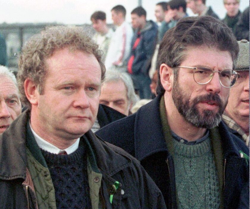 Martin McGuinness, the Sinn Fein chief negotiator (left) and Sinn Fein’s president Gerry Adams as they participate in the Bloody Sunday anniversary march in Derry/Londonderry, Northern Ireland, in 1998. McGuinness, an IRA and Sinn Fein leader who became