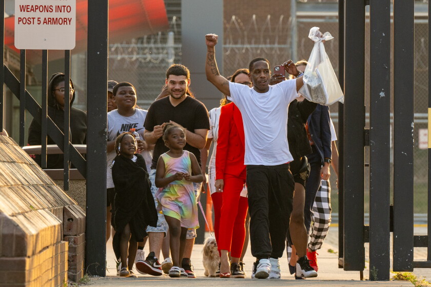 Tyrone Clay, arms raised, surrounded by family and attorneys, walks out of Cook County Jail after prosecutors drop charges against him in the 2011 slaying of Chicago police Officer Clifton Lewis, Wednesday, June 21, 2023.