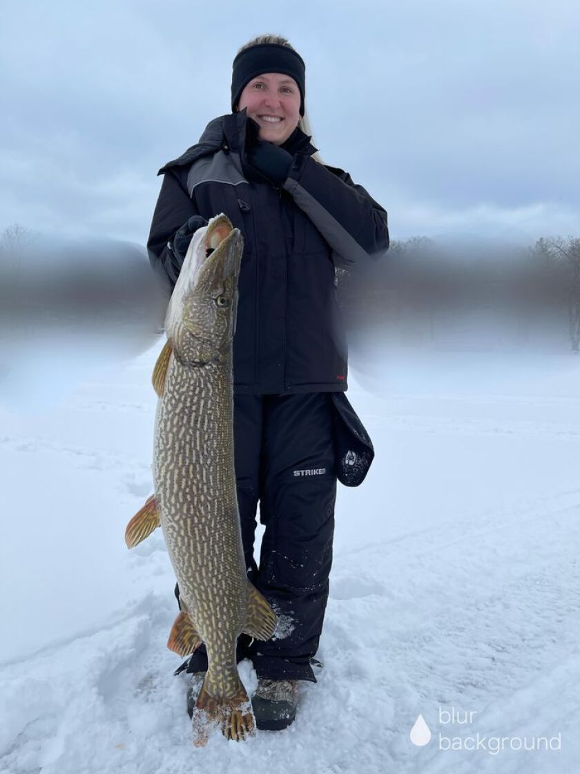 Full length view of Stefi Modrzejewski holding a memorable northern pike from Lake County. Provided photo