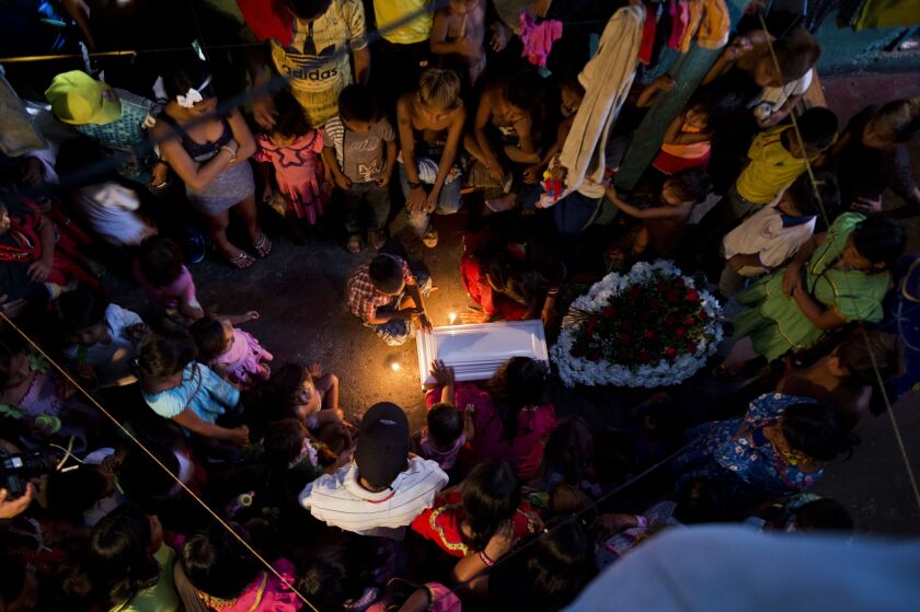 Colombians attend a funeral of baby Eustesy, 4 months old, who died last night by unknown causes, in Cali, Colombia, on January 25, 2015. LUIS ROBAYO/AFP/Getty Images