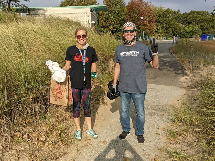 Anna Hendricks and John Jay began their cleanup at the Shore Shore Natural Area Saturday during Adopt-a-Beach. Credit: Dale Bowman