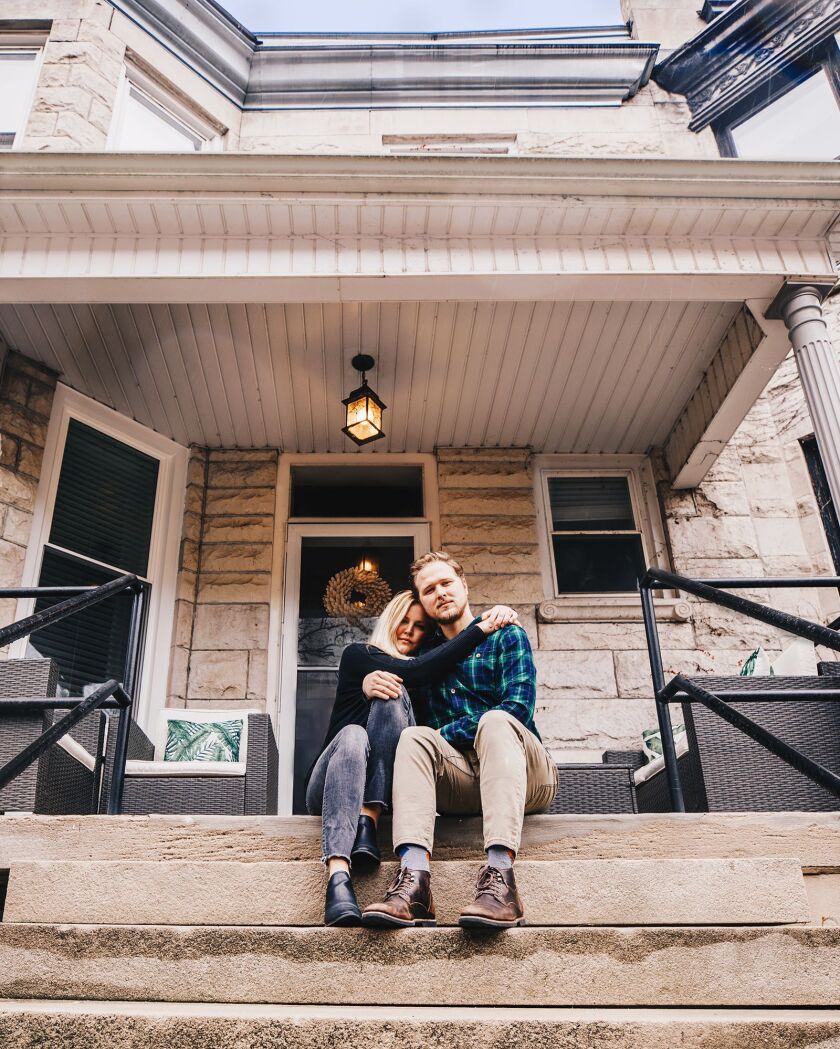 Angela Conners Treimer poses with her husband, Ben, on their front steps.