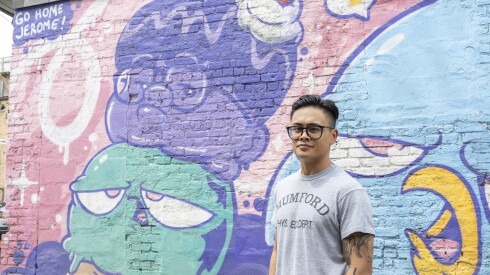 Artist Jerome Tiunayan stands across the alley from the Little Jerome mural with another mural, one that he painted with his friend and fellow Chicago muralist, Birdmilk.