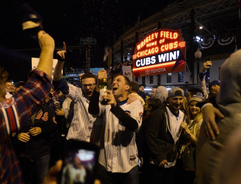 Cubs fans celebrate outside Wrigley Field after Game 5. | AP