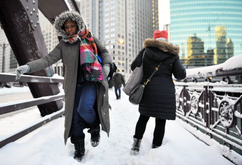 Commuters slug through the snow near Franklin and Wacker. | Al Podgorski/Sun-Times Media