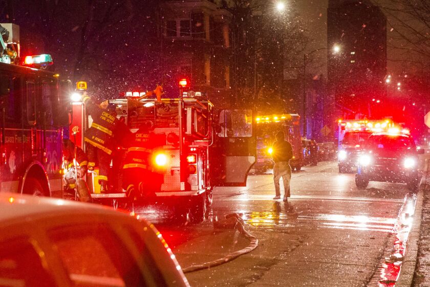Firefighters begin to pack up after extinguishing a house fire at the 3900 block of West Congress Parkway. | Tyler LaRiviere/Sun-Times