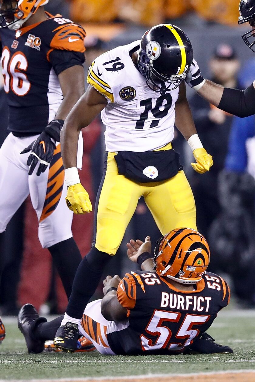 Steelers receiver JuJu Smith-Schuster stands over the Bengals’ Vontaze Burfict after a hit . (Andy Lyons/Getty Images)