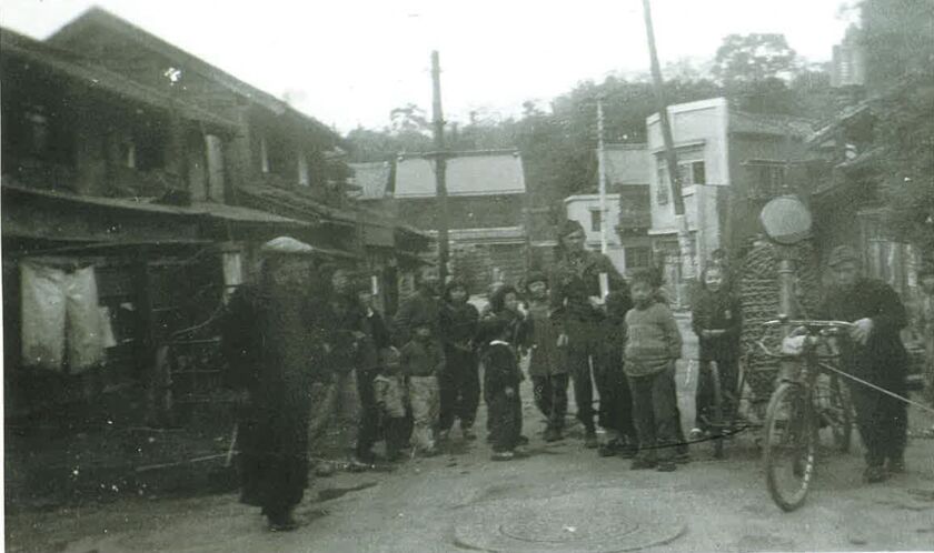 Howie Garst hands out candy to children outside Sugamo Prison in Tokyo after World War II. | Provided photo
