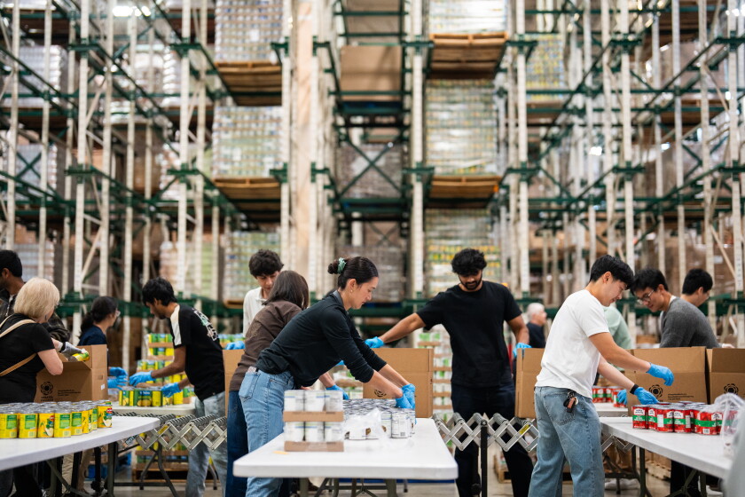 Volunteers help pack food at the Greater Chicago Food Depository warehouse in Archer Heights on Friday, September 11, 2026.