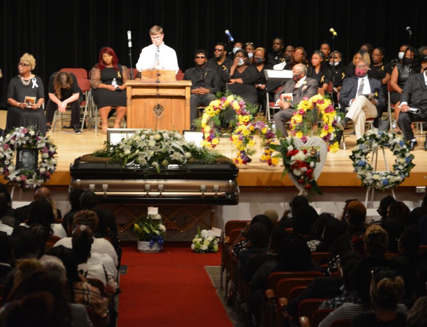 Paul DeArmond, 26, Jelani Day’s childhood friend, speaks at his service Saturday at Danville High School in Danville.