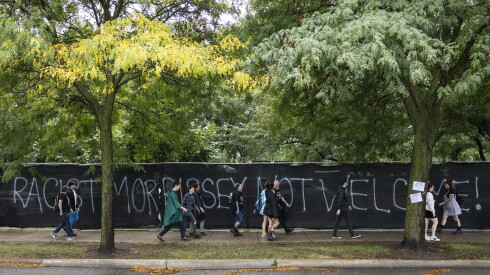 Graffiti reads “Racist Morrissey not welcome!” on the exterior fence at Douglass Park.