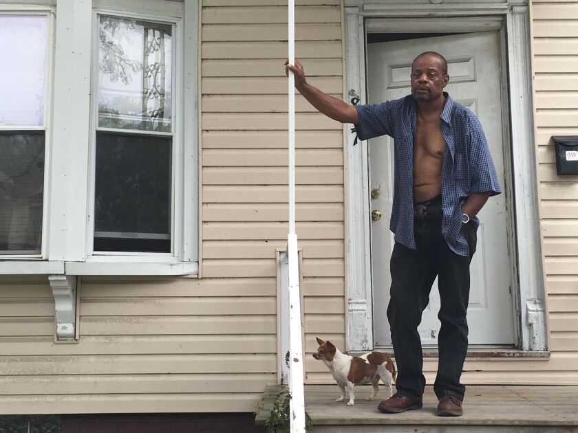 “I could have been sitting there on the couch,” said Earnest Falkner, pointing to the bullet hole in his window. | Mitch Dudek/Sun-Times