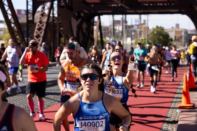 Runners cross the Cermak Road Bridge in Pilsen near the 21-mile mark during the 2025 Bank of America Chicago Marathon.