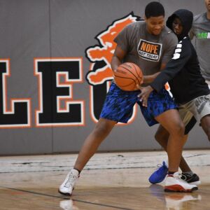 Timothy Howard of Leo backs a man down during practice. Worsom Robinson/For the Sun-Times.