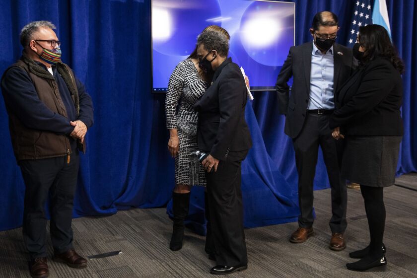 Mayor Lori Lightfoot hugs Karina Ayala-Bermejo, of Instituto Del Progreso, after discussing the videos of 13-year-old Adam Toledo, who was fatally shot by a Chicago police officer, during a news conference at City Hall, Thursday, April 15, 2021.