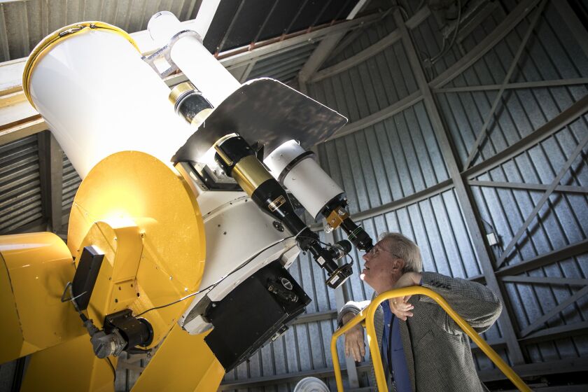 Astronomer Larry Ciupik looks through the telescope at the Doane Observatory of the Adler Planetarium. | Ashlee Rezin/Sun-Times