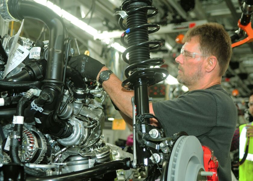 Doug Jatczak works on the motor-and-drivetrain assembly line Monday at Ford’s Torrence Avenue plant on the Southeast Side, using equipment that was installed during a $1 billion expansion.