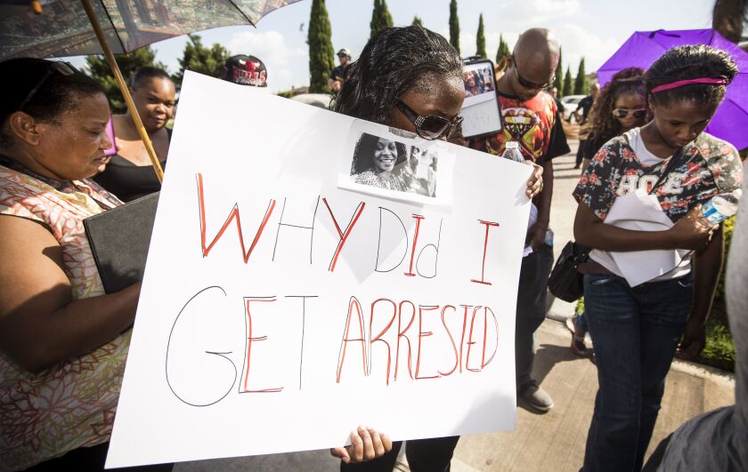 Margaret Hilaire, center, prays during a demonstration in Katy, Texas on July 26 calling for the firing and indictment of Texas State Trooper Brian Encinia. | Brett Coomer/Houston Chronicle, distributed by the Associated Press