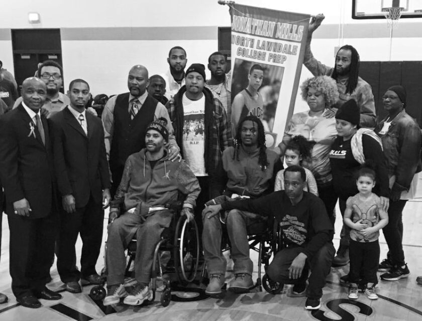(L-R) In wheelchairs, gun violence victims Coach Shawn Harrington and former North Lawndale player Jermaine Winfield at an event honoring Jonathan Mills, a former North Lawndale star who was gunned down on the sidewalk on the way to the gym. Mills’ mother
