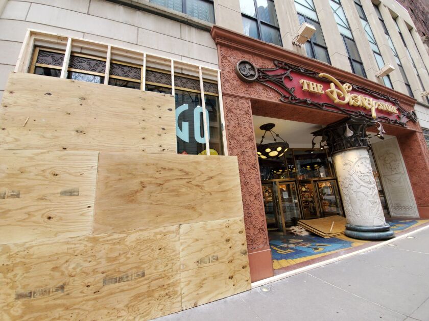 A handful of stores were boarded up on the Magnificent Mile Saturday before Gov. J.B. Pritzker’s stay-at-home order takes effect.