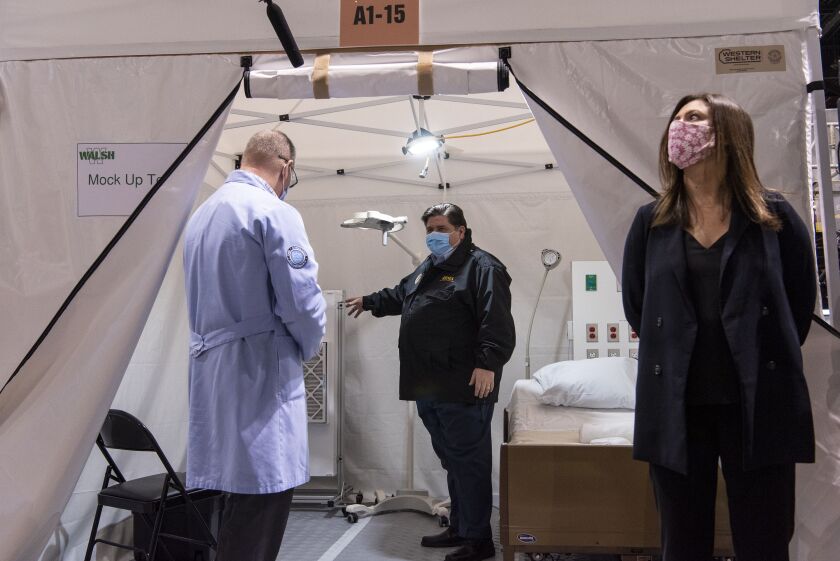 Gov. J.B. Pritzker tours one of the patient rooms at the COVID-19 alternate care facility in Hall C at McCormick Place in Chicago last week.