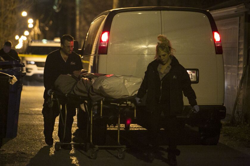 Technicians with Allied Services remove the body of a 19-year-old man who was shot in the head in the 5300 block of South Hermitage early Wednesday, March 23, 2016. | Ashlee Rezin/Sun-Times