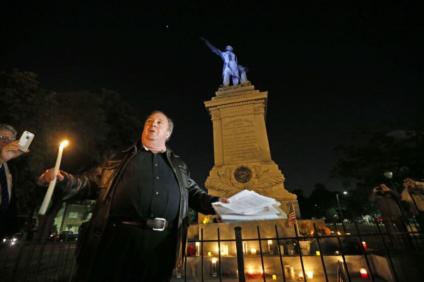 Charles Lincoln speaks during a candlelight vigil at the statue of Jefferson Davis in New Orleans early Monday. New Orleans has begun taking down Confederate statutes, becoming the latest Southern body to divorce itself from what some say are symbols of r