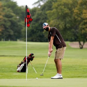 Mount Carmel’s Michael Dobrich lines up a putt during practice at Jackson Park Golf Course.