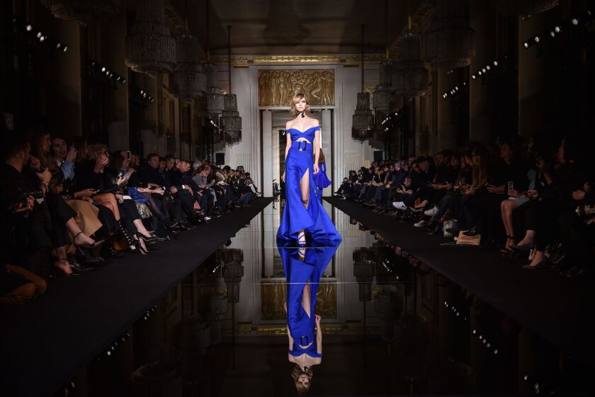 A model presents a creation by Italian fashion designer Donatella Versace, as part of the Atelier Versace Spring Summer 2015-16 Haute Couture fashion collection in Paris, Sunday, Jan. 25, 2015. (AP Photo/Zacharie Scheurer)