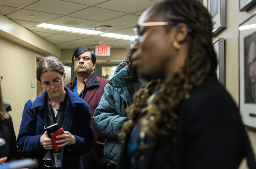 Resilience Healthcare CEO Manoj Prasad listens as Dr. Chidinma Osineme speaks to reporters Wednesday about conditions at West Suburban Medical Center in Oak Park.