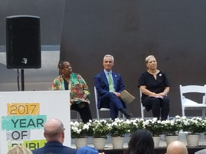 Mayor Rahm Emanuel keeps an eye on a protester from the stage at the Daley Plaza ceremony marking the 50th anniversary of the Picasso sculpture. | Nader Issa/Sun-Times