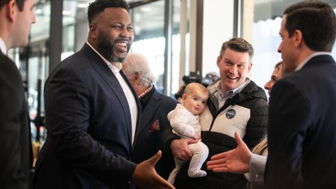 Chicago mayoral candidate state Rep. Kam Buckner greets diners while 34th Ward aldermanic candidate Bill Conway carries his daughter Billie during campaign stops on Election Day at Manny’s Deli in the West Loop, Tuesday. Feb. 28.