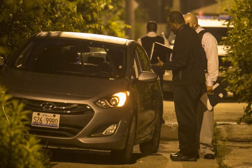 Cook County medical examiner’s investigator Justin Pratt at the scene of a fatal shooting on the South Side. | Ashlee Rezin / Sun-Times files