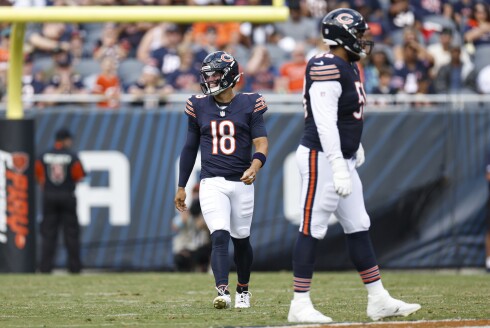 Chicago Bears quarterback Caleb Williams (18) smiles as he walks on the field during the first half of an NFL preseason football game against the Cincinnati Bengals, Saturday, Aug. 17, 2024, in Chicago.