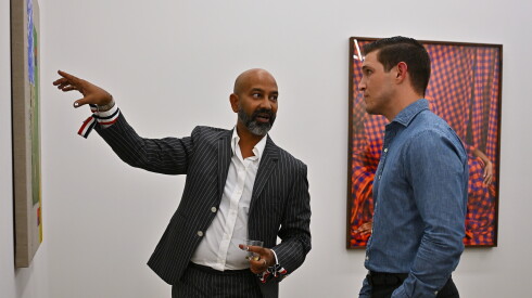 Dancer-artist Brendan Fernandes discusses his artwork with collector Garrett Schwindt during the Chicago Exhibition Week at Monique Meloche Gallery.