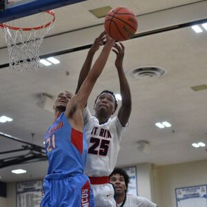 Kenwood’s Darnell King (21) and St Rita’s Jeremiah Oden (25) go up for a rebound. Worsom Robinson/For the Sun-Times.
