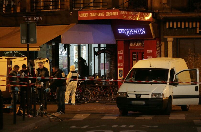 Forensic police search for evidence outside the La Belle Equipe cafe, rue de Charonne, at the site of an attack in Paris. A series of gun attacks across the city killed more than 120 people. | Jacques Demarthon/AFP/Getty Images
