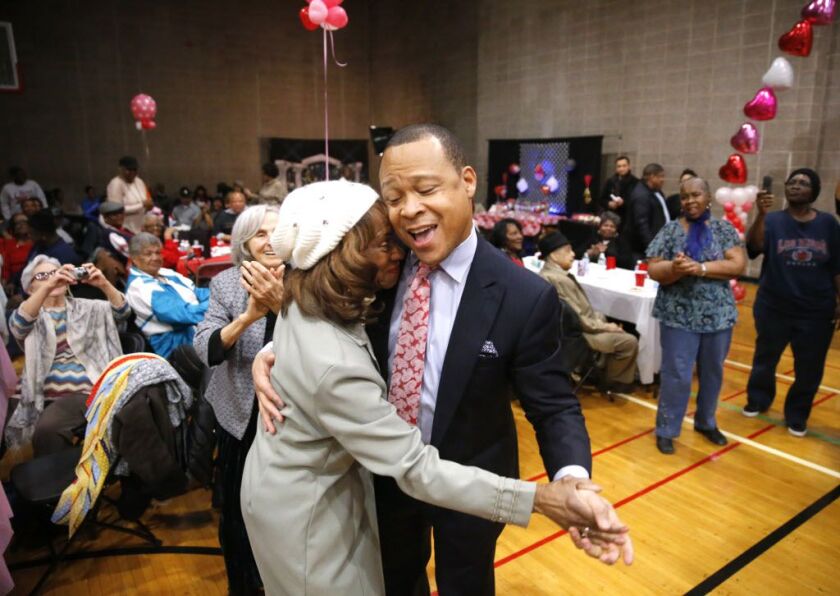 Rep. Ken Dunkin dances with a constituent at a pre-Valentines Day bingo party he hosted at a community center in Chicago last month. (AP Photo/Charles Rex Arbogast)