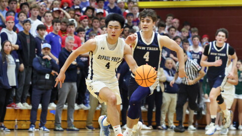 DePaul Prep's Rykan Woo (4) moves the ball against New Trier's Christopher Kirkpatrick (4) during the game at Loyola.