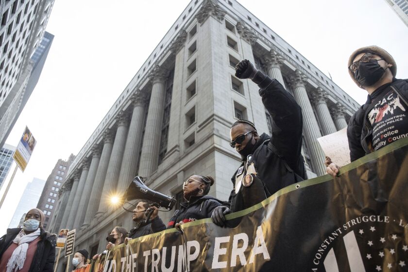 Chicago activist Michael Ben Yosef raises his fist in front of City Hall in the Loop to protest the acquittal of Kyle Rittenhouse, Saturday afternoon.